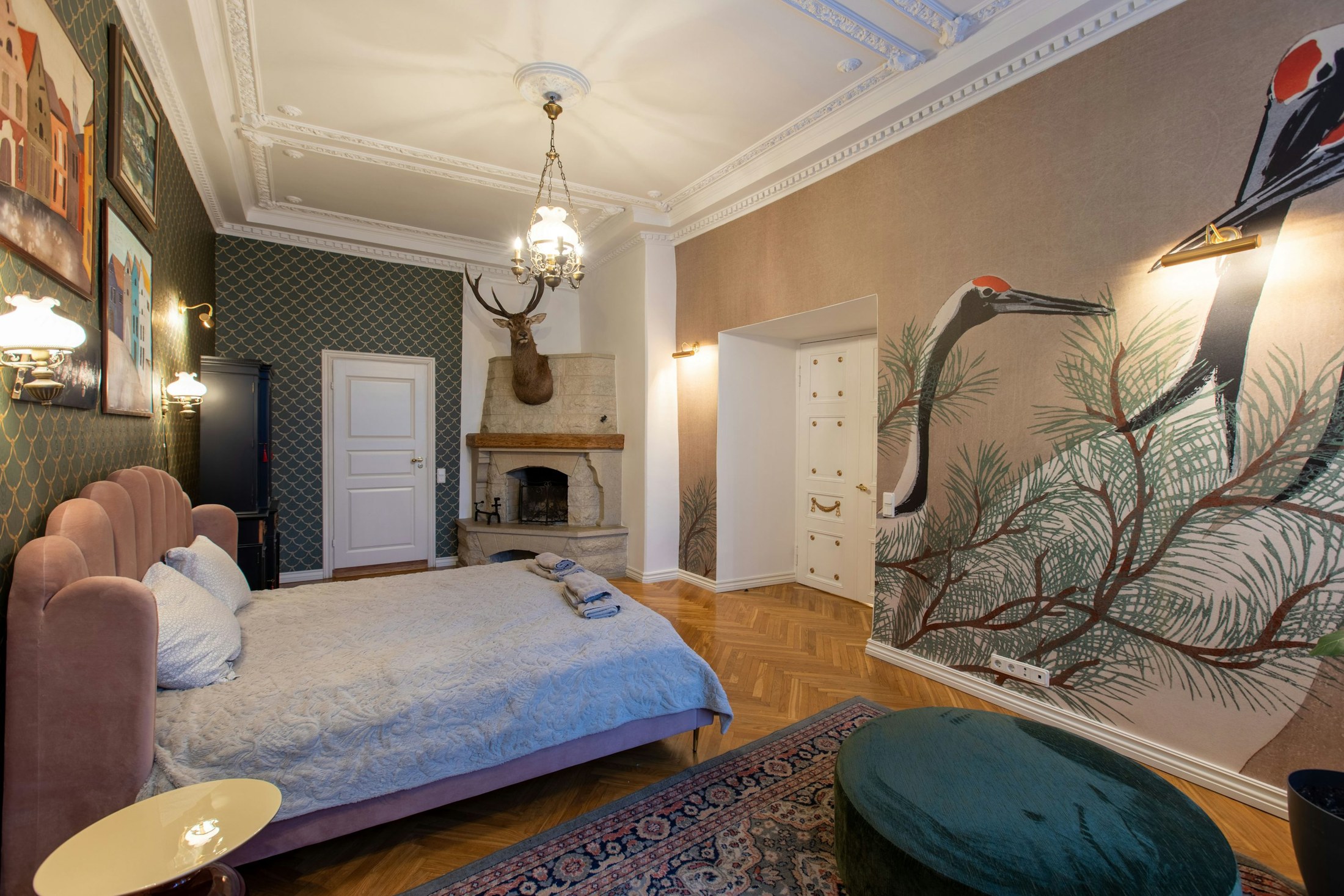 Crane mural and repeating wallcovering in a finished bedroom